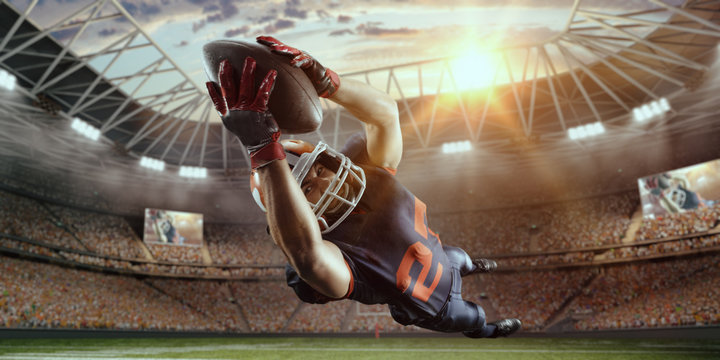 American football player jumps and catches the ball in flight in professional sport stadium