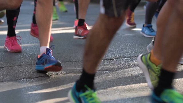 Marathon runners legs only. Slow motion.