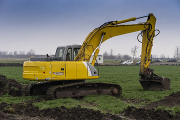 Excavators and bulldozers preparing the ground for the construction of a factory