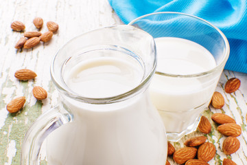 almond milk in a small pitcher and a glass