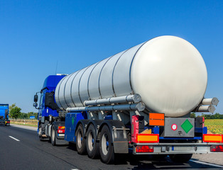 Large automotive fuel tanker truck driving on highway. Fuel transportation