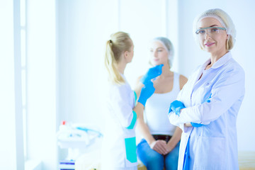 Obraz premium Beautiful woman face near doctor with syringe.