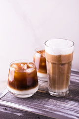 Iced coffee in glasses with milk. Black background