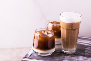 Iced coffee in glasses with milk. Black background