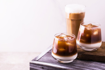 Iced coffee in glasses with milk. Black background