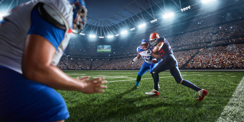 Naklejka premium American football players preforms an action play in professional sport stadium