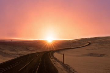 Naklejka premium Asphalt country road at sunset.inspirational concept travel on empty road.scene of dramatic sky over asphalt road.
