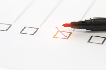 Checklist concept - Red pen checkmark on paper checklist box for questionnaire form.
