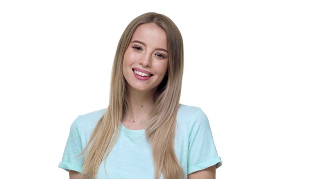 Portrait of caucasian woman 20s wearing basic t-shirt laughing with perfect smile, isolated over white background in studio. Concept of emotions