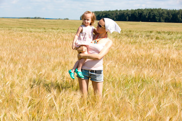 Mom and daughter in a cereal field