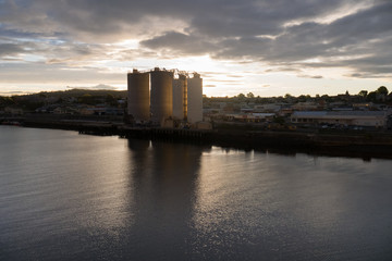 Sun setting behind silos in Devonport, Tasmania, Australia
