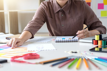 Stylish fashion designer working as fashion designers measure as sketches in her workshop of new collection in art, profession and job occupation, Creative Design and Artistic Concept