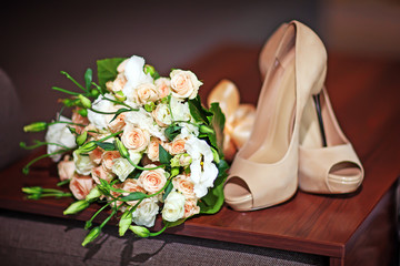 wedding bouquet and bridesmaid shoes, boutonniere on wooden board