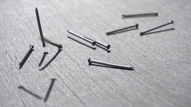 Falling metal nails slow motion 