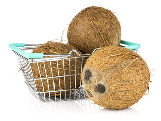 Three coconuts in a shopping basket isolated on white background brown fibrous shell.