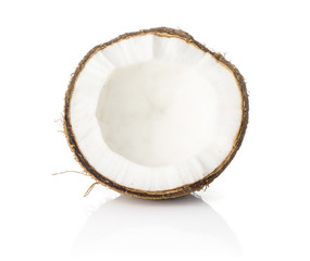 One coconut section half isolated on white background cracked brown fibrous shell with milk meat.