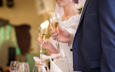 Bride and groom holding wedding champagne glasses