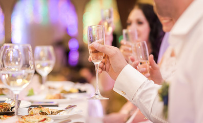 Bride and groom holding wedding champagne glasses