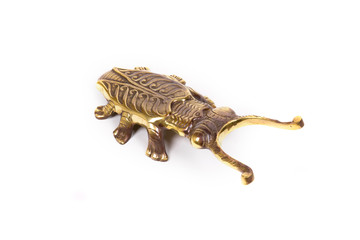 Ancient statuette of bronze beetle on white background