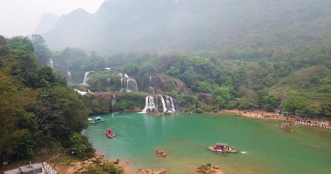 AERIAL 4K: over the Ban Gioc Waterfall at cloudy March  - the most magnificent waterfall in Vietnam