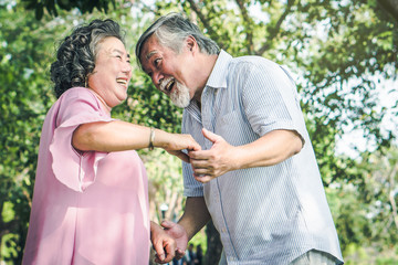 Happy elderly couple with lifestyle after retiree concept. Lovely asian seniors couple embracing together in the park in the morning.