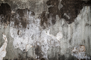 Full frame background of weathered, damaged and dirty concrete wall with plaster peeled off with vignette.