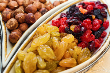 bowl with mixed nuts and dried fruits such as raisins, almonds, hazelnuts and cashews.  Healthy food and snack