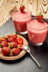 healthy strawberry yogurt with fresh berries on old wooden background