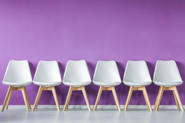 Row of chairs against wall