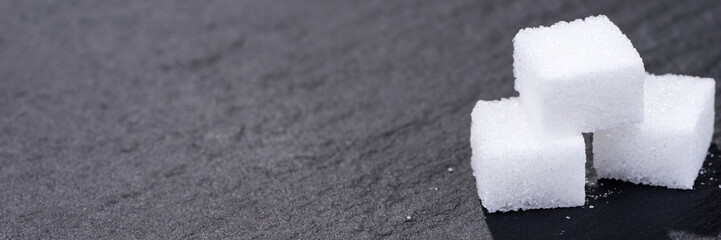 Three pieces of sugar cubes isolated on black background