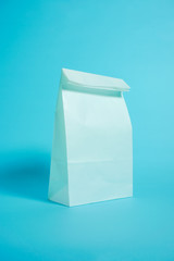 White paper bag. Image of shopping, takeout or sale, etc. 白い紙袋　買い物、テイクアウト、販売などのイメージ　水色背景