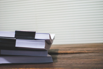 Stack of business report paper file on wooden table.