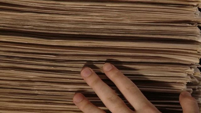 Hand with a bunch of newspaper