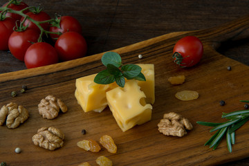 cheese on wooden background with walnut