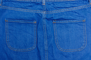 Part of blue denim wear with pockets. Details