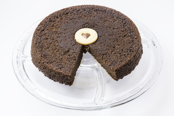 chocolate cake with a heart paste in the center on a glass plate
