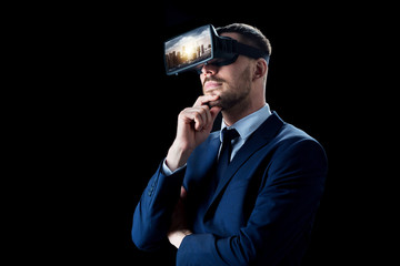 Naklejka premium 3d technology, virtual reality, cyberspace and augmented reality concept - young businessman with singapore city on virtual headset or 3d glasses screen over black background