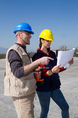 young engineer girl and an elderly skilled worker fitting a photovoltaic plant