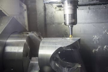 The spindle tile type 5 axis CNC milling machine cutting the automotive part.
