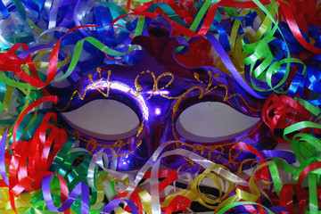 Anonymous violet carnaval mack with spripes, ribbons, confetti, tinsel. 