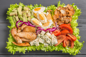 Cobb salad with fried chicken, avocado, eggs and tomatoes