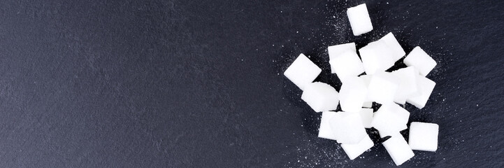 Pile of sugar cubes isolated on black background