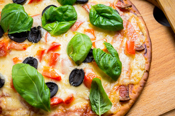 Fresh pizza served on wooden table. Selective focus.