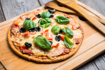 Fresh pizza served on wooden table. Selective focus.