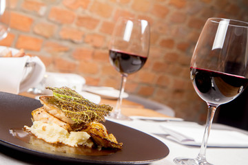 Sturgeon, savoy cabbage, mushrooms broth, mashed potato with butter served in a restaurant