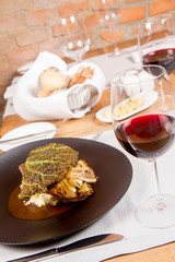 Sturgeon, savoy cabbage, mushrooms broth, mashed potato with butter served in a restaurant