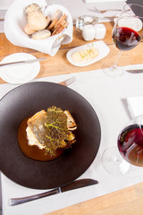 Sturgeon, savoy cabbage, mushrooms broth, mashed potato with butter served in a restaurant