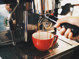 Asian man making a coffee in cafe.