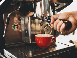 Asian man making a coffee in cafe.