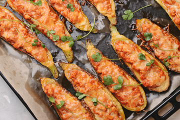 Baked stuffed zucchini with meat in a pan